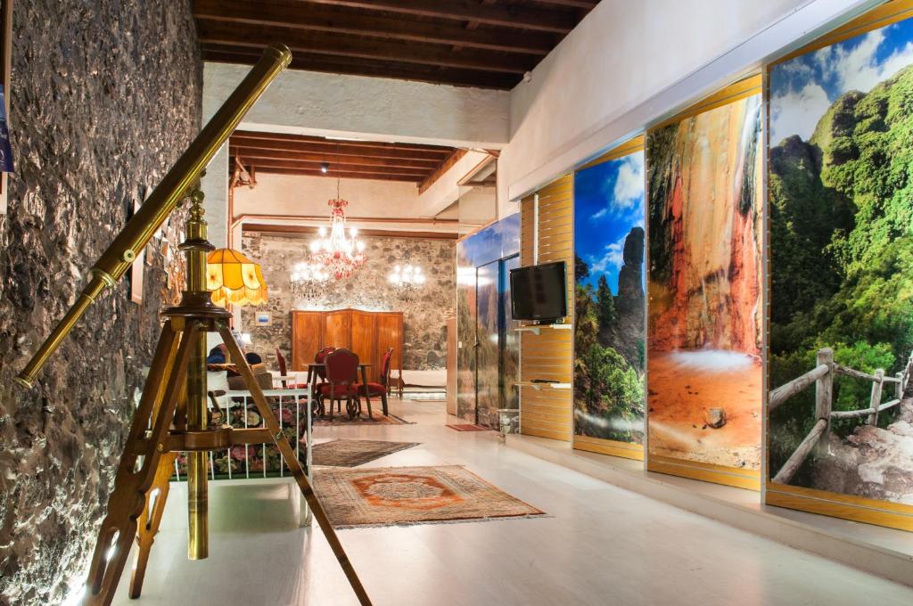 a room with paintings on the walls and a tripod at Casa Amelia in Santa Cruz de la Palma