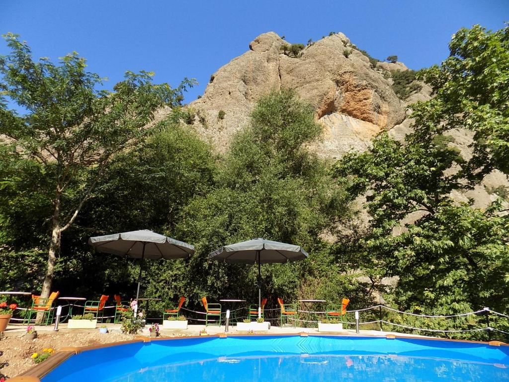 a swimming pool with a mountain in the background at Guesthouse Eleftherios in Kalavrita