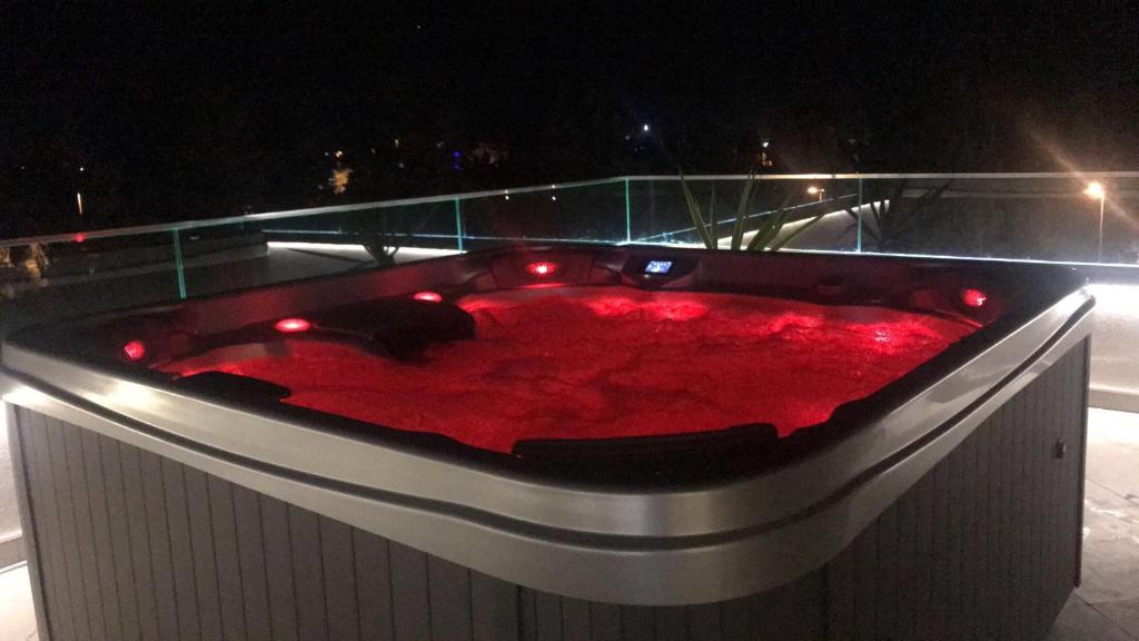 a red bath tub with lights on top of a building at Boutique Hotel "Salina" in Ulcinj