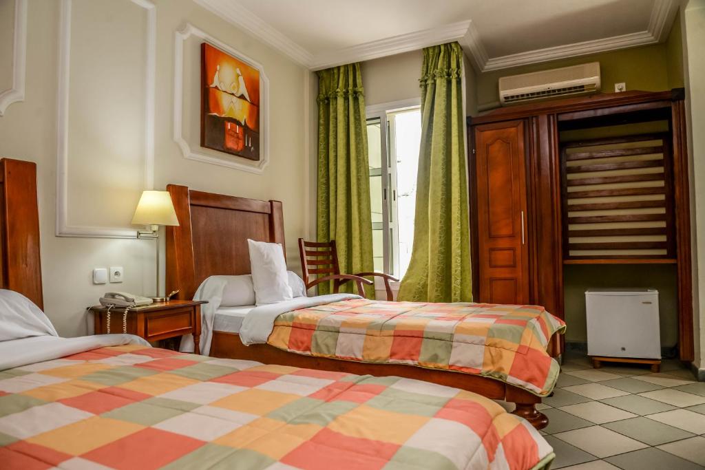 Postel nebo postele na pokoji v ubytování Tchero Hotel