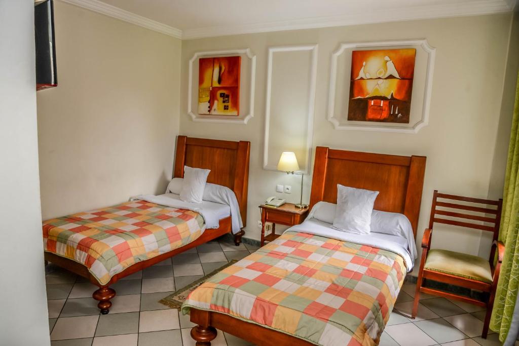 Postel nebo postele na pokoji v ubytování Tchero Hotel