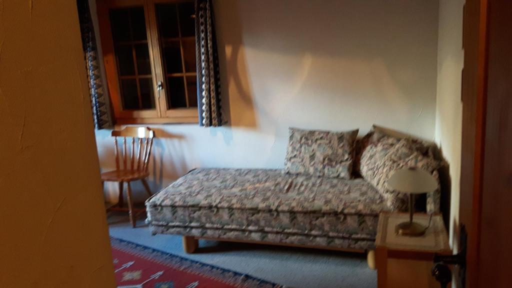a bedroom with a bed and a table and a chair at Chalet Blettner in Randa