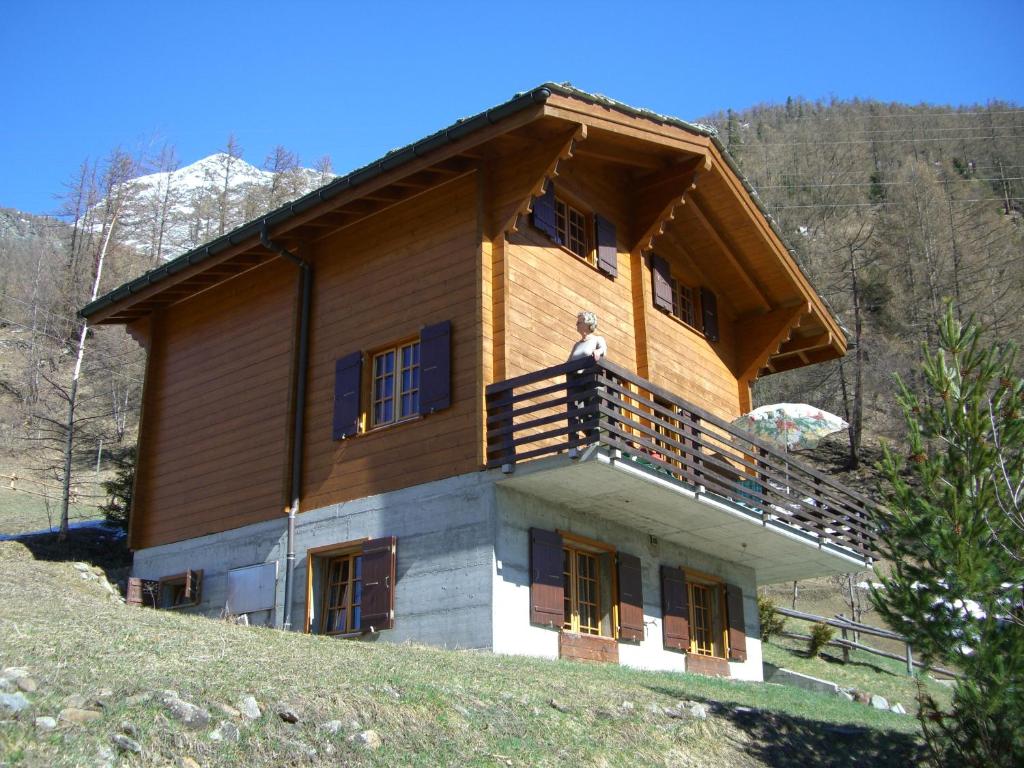 a man standing on the balcony of a house at Chalet Blettner in Randa