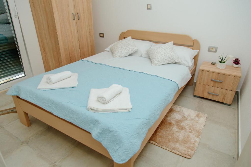 Postel nebo postele na pokoji v ubytování Apartmani Mozaici