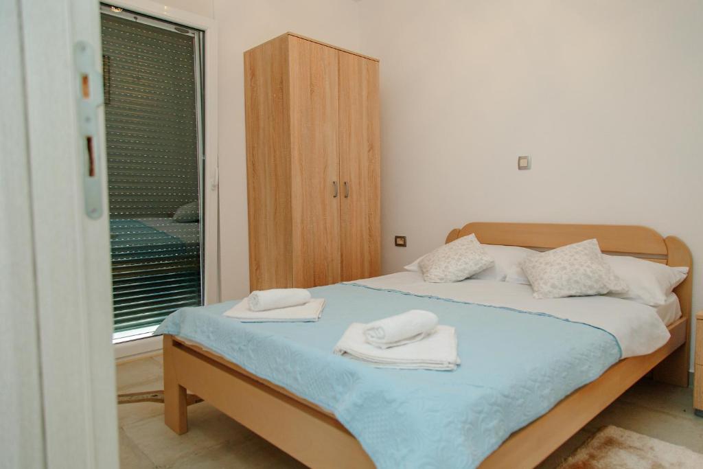 Postel nebo postele na pokoji v ubytování Apartmani Mozaici