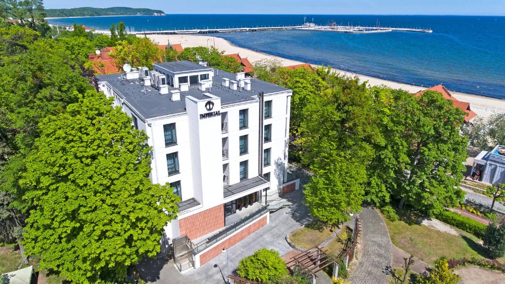 an aerial view of a white building with trees at Rewita Imperial in Sopot