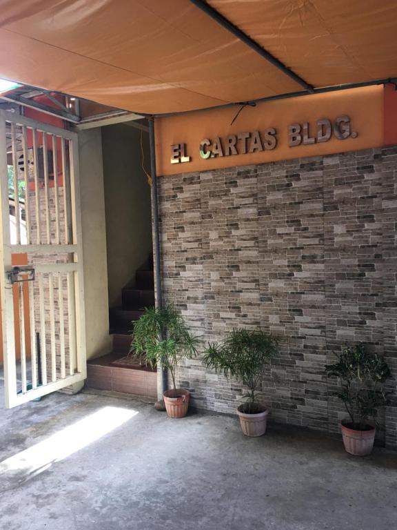 a building with two potted plants in front of it at Affordable La Union in Caba