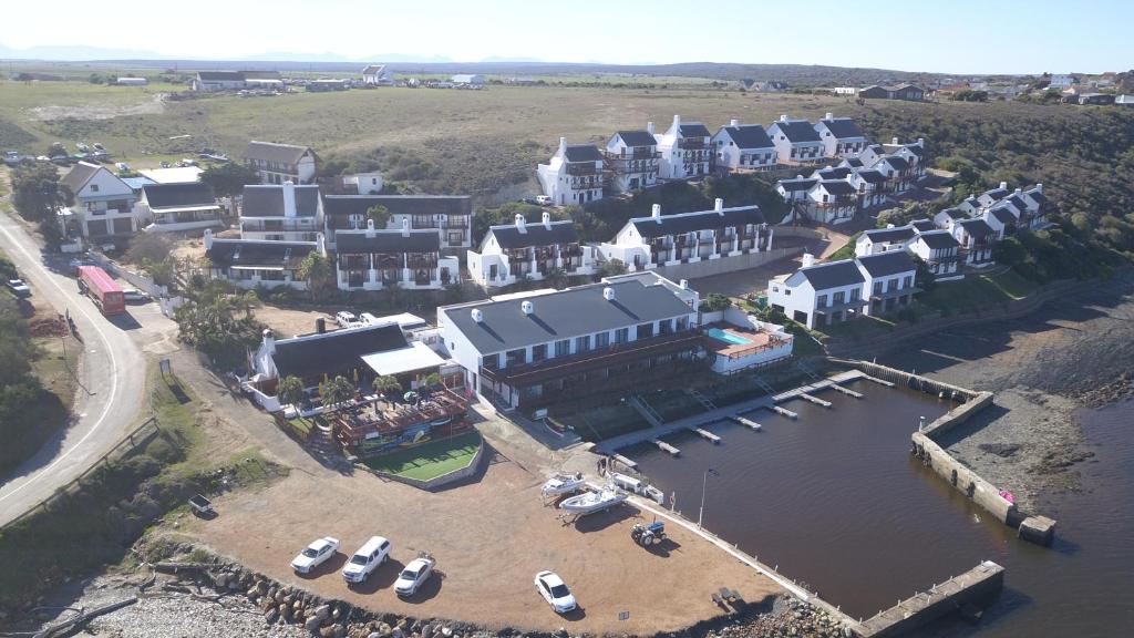 an aerial view of a resort with boats in the water at Breede River Lodge in Witsand