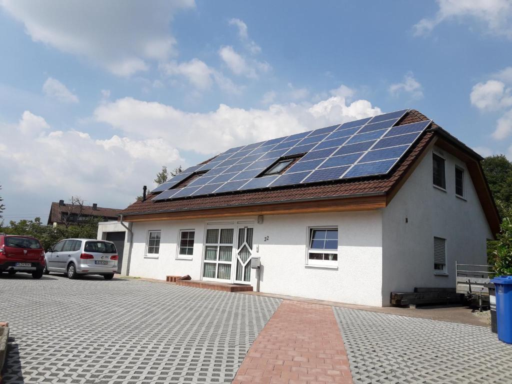 a house with solar panels on the roof at Ferienwohnung Frühlingstraße in Mehlbach