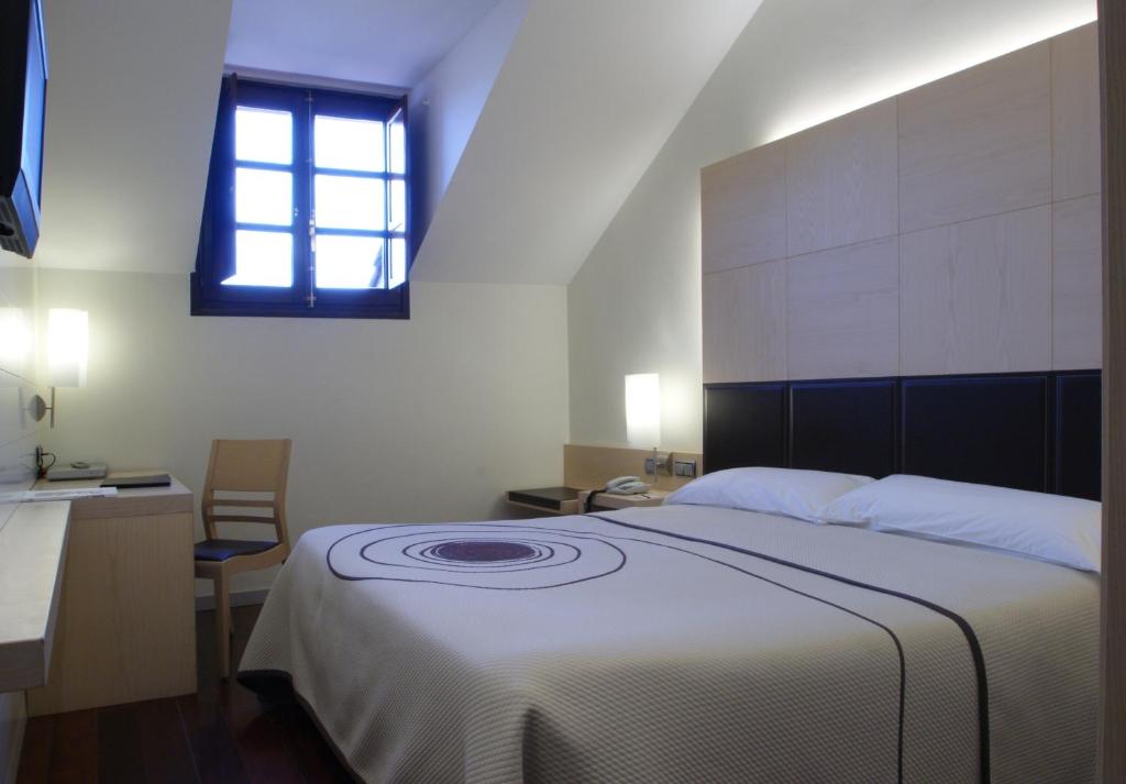 Postel nebo postele na pokoji v ubytování Hotel Mozart