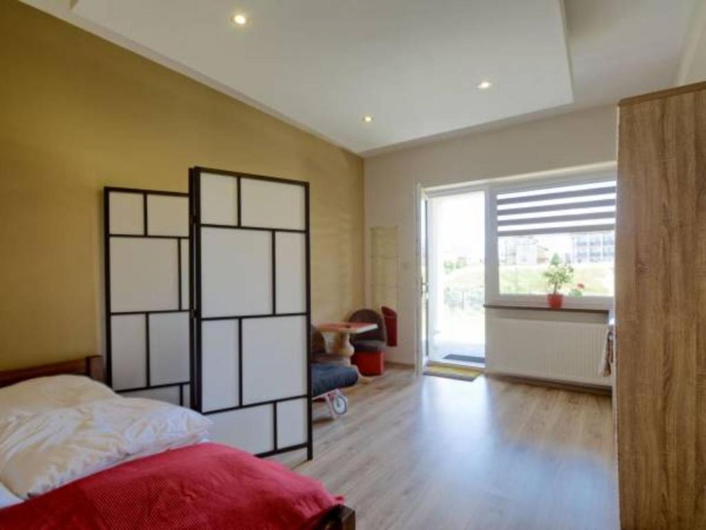 Posteľ alebo postele v izbe v ubytovaní Mini Apartamenty Dominika