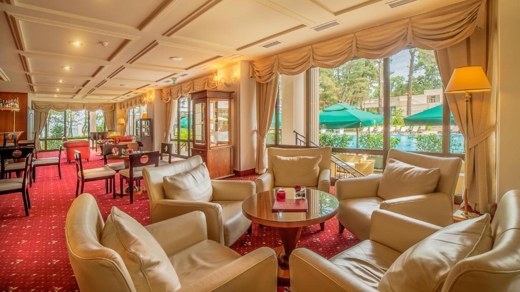 a hotel lobby with couches and a table at Kobuleti Georgia Palace Hotel & Spa in Kobuleti