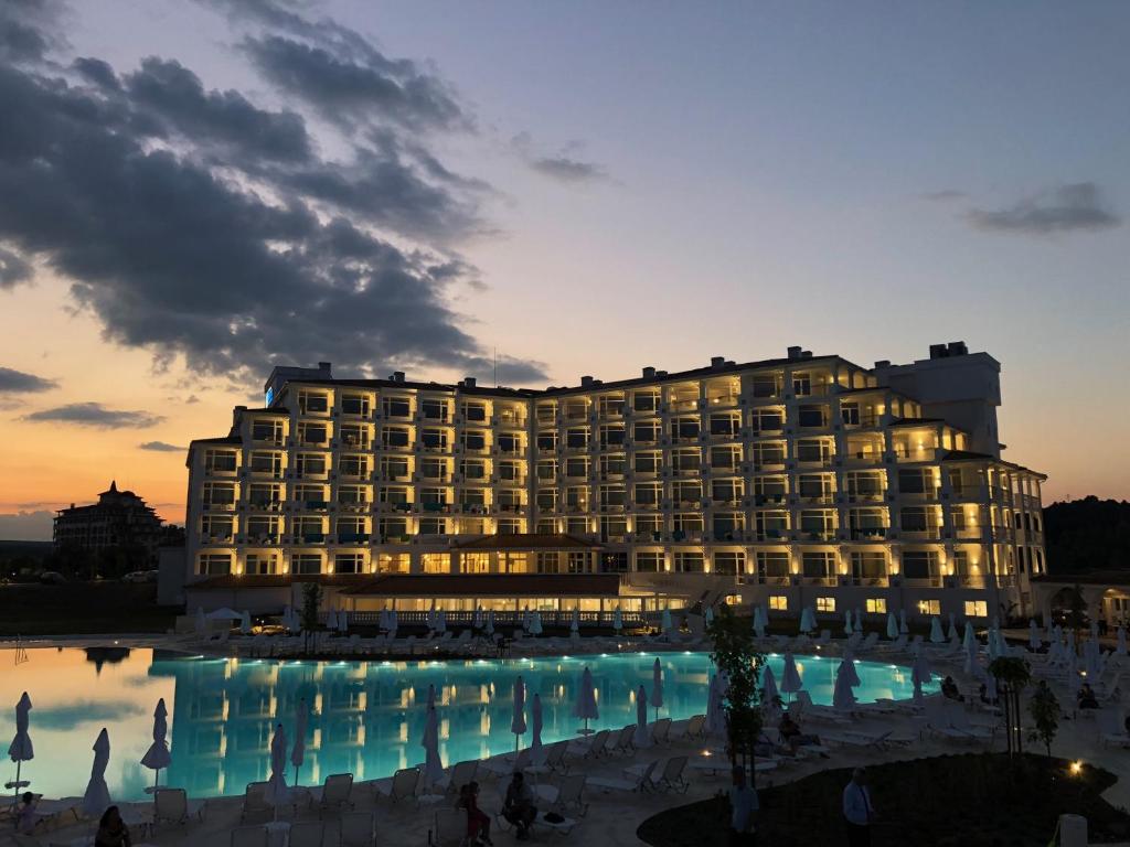 a hotel with a large pool in front of it at Sunrise Blue Magic Resort - All Inclusive in Obzor