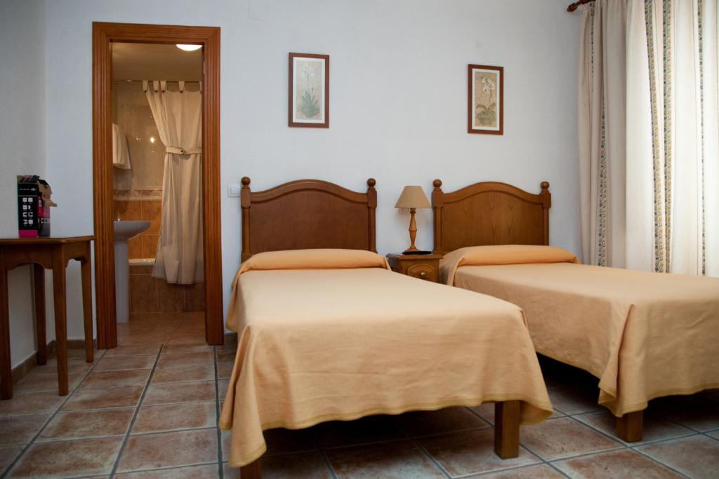 Postel nebo postele na pokoji v ubytování Hostal El Rincón