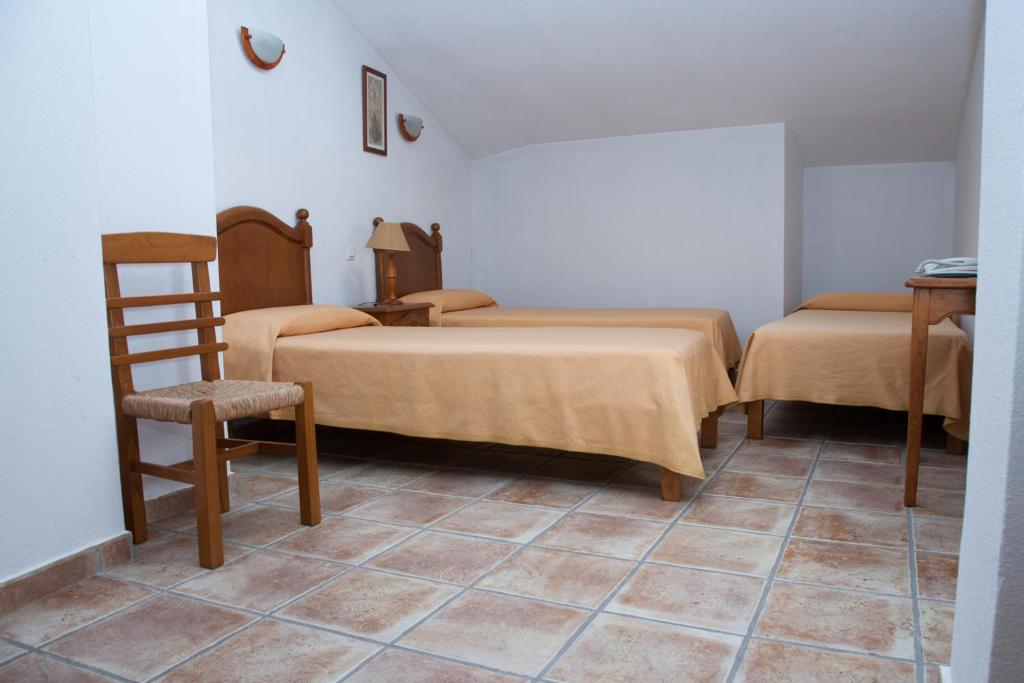 Postel nebo postele na pokoji v ubytování Hostal El Rincón
