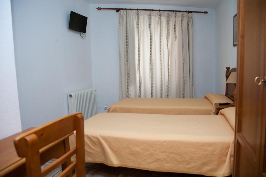 Postel nebo postele na pokoji v ubytování Hostal El Rincón