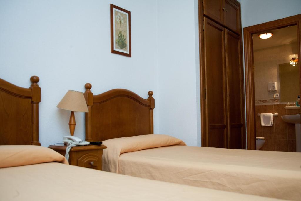 Postel nebo postele na pokoji v ubytování Hostal El Rincón