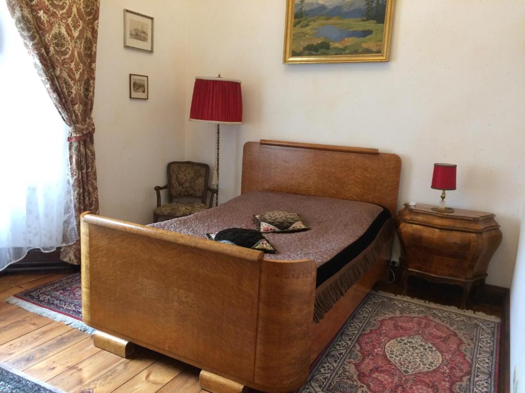 a bedroom with a bed with a dog laying on it at Ēdoles Pils in Ēdole