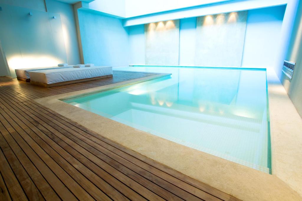 a swimming pool in a room with a wooden floor at Libertad Hotel Buenos Aires in Buenos Aires