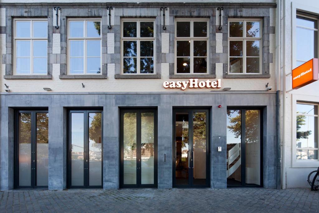 a facade of a building with the entrance to easy hotel at easyHotel Maastricht City Centre in Maastricht