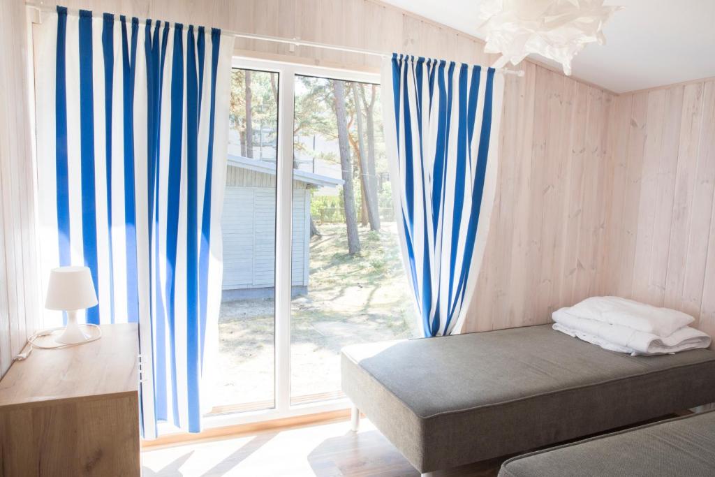 a bedroom with a bed and a large window at Archipelag in Ustka