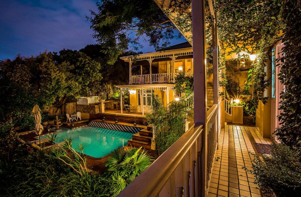 a house with a swimming pool in the yard at Goble Palms Guest Lodge & Urban Retreat in Durban