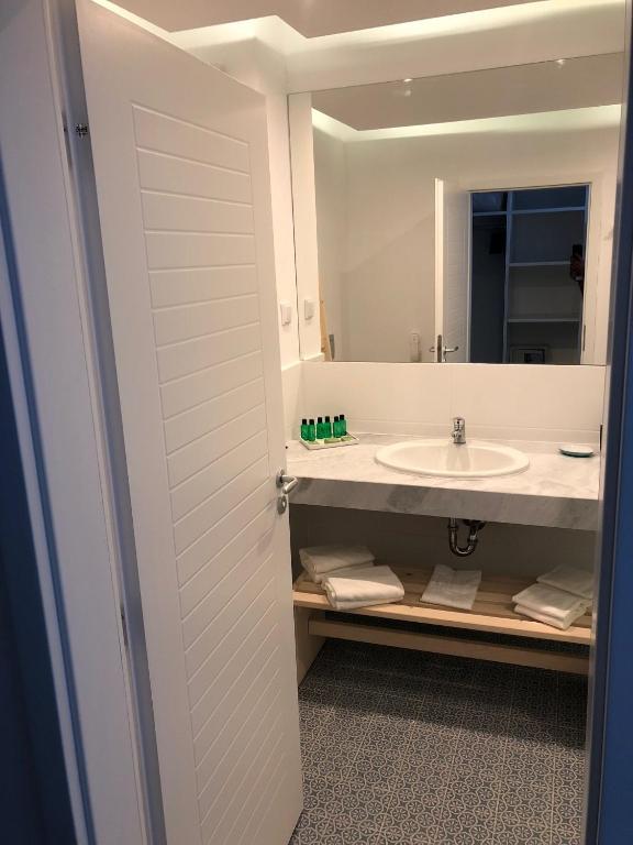 a bathroom with a sink and a mirror at Sunrise Blue Magic Resort - All Inclusive in Obzor
