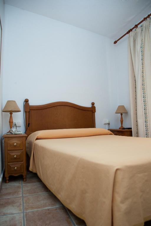 Postel nebo postele na pokoji v ubytování Hostal El Rincón