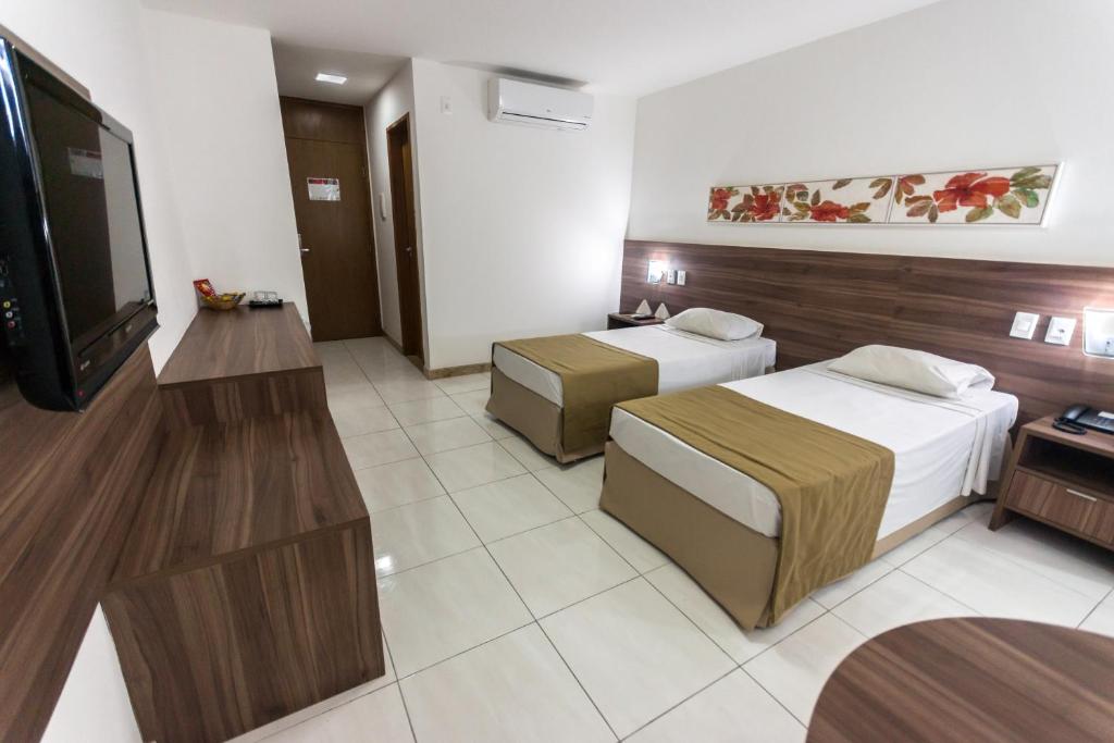 Postel nebo postele na pokoji v ubytování Cambuci Hotel