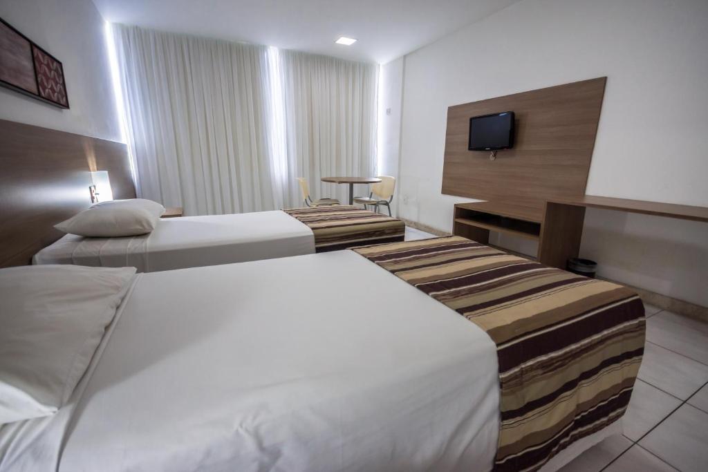 Postel nebo postele na pokoji v ubytování Cambuci Hotel