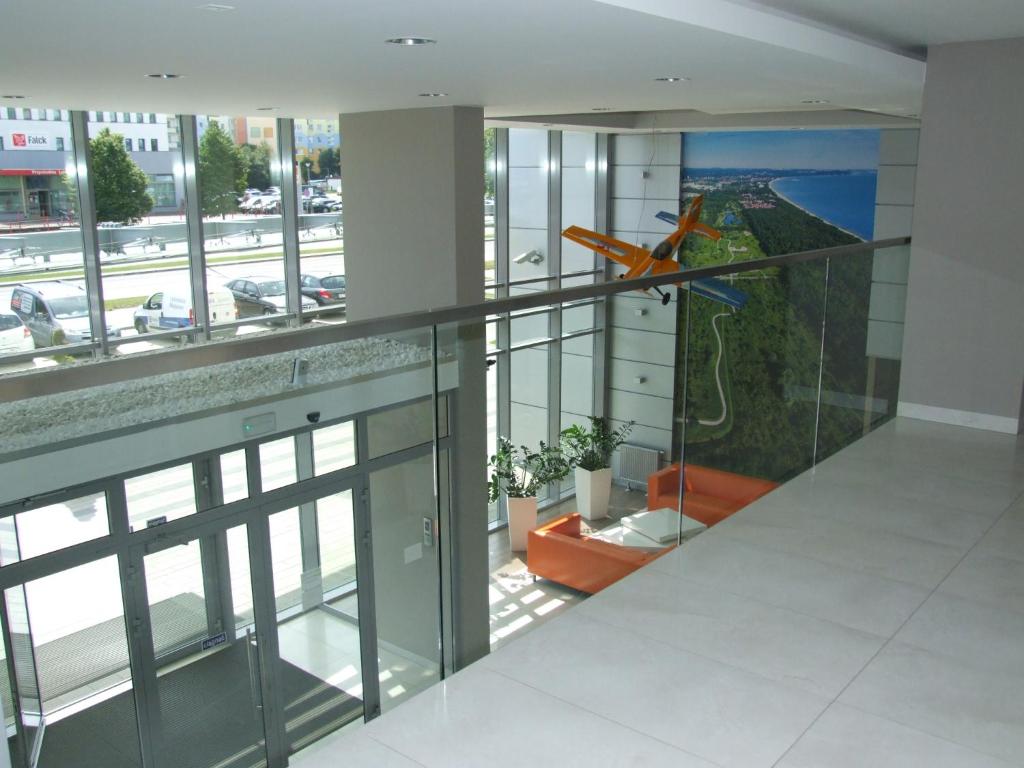 a room with a balcony with a plane on the wall at Apartament nad morzem, Gdańsk Zaspa in Gdańsk