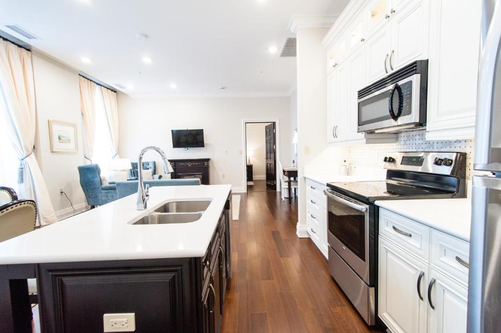 a kitchen with a sink and a stove top oven at Sydney Boutique Inn & Suites in Charlottetown
