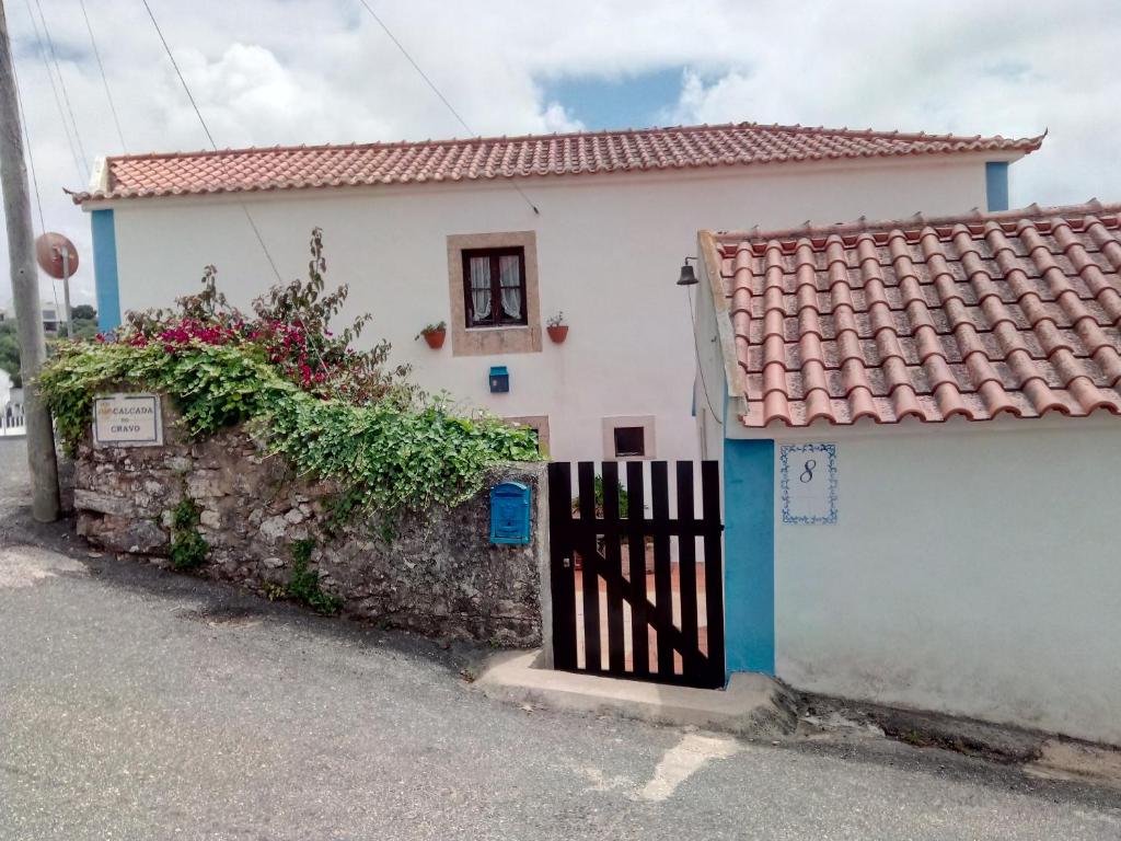Santo IsidoroにあるCasa do Cravoの門と柵のある白い家