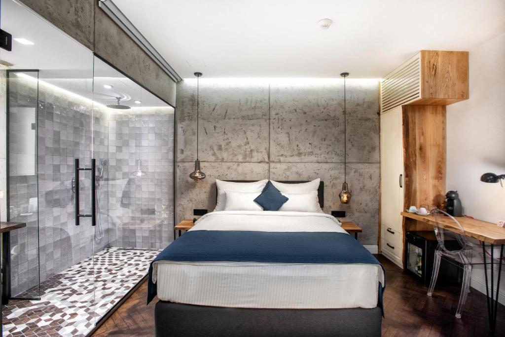 a bedroom with a bed and a glass wall at One Luxury Suites in Belgrade