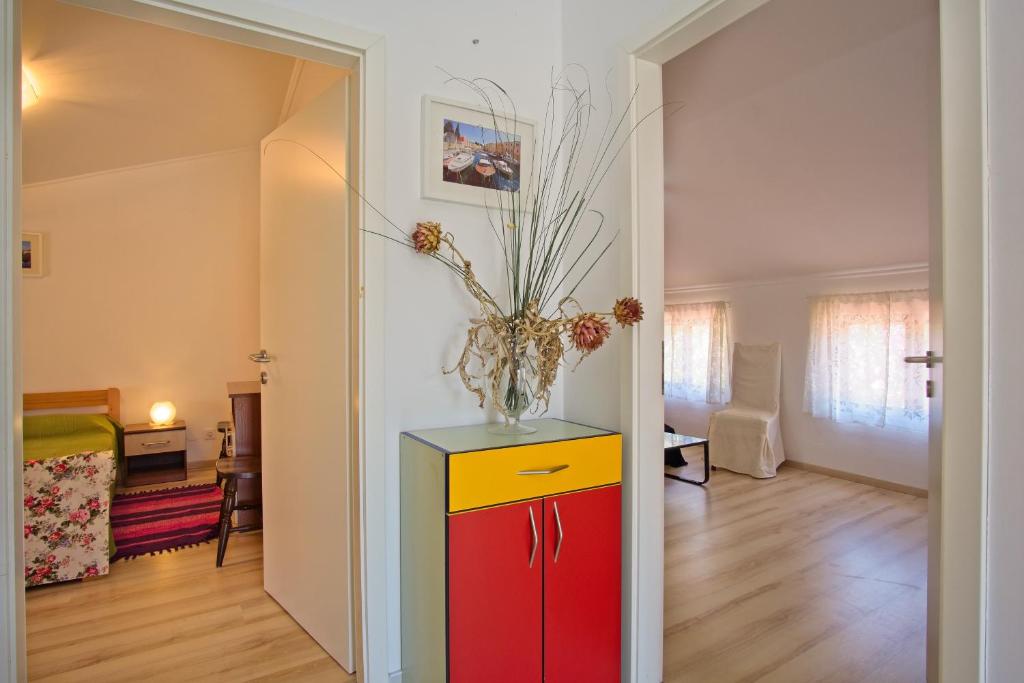 a room with a brightly colored cabinet and a living room at House Verica in Veli Lošinj