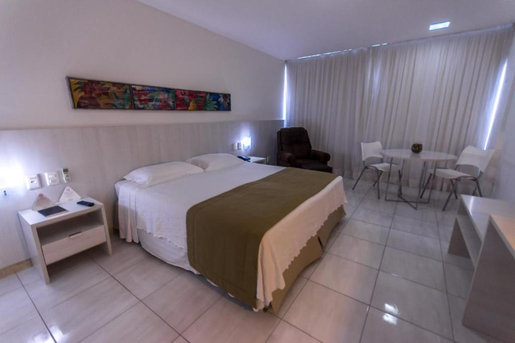 Postel nebo postele na pokoji v ubytování Cambuci Hotel