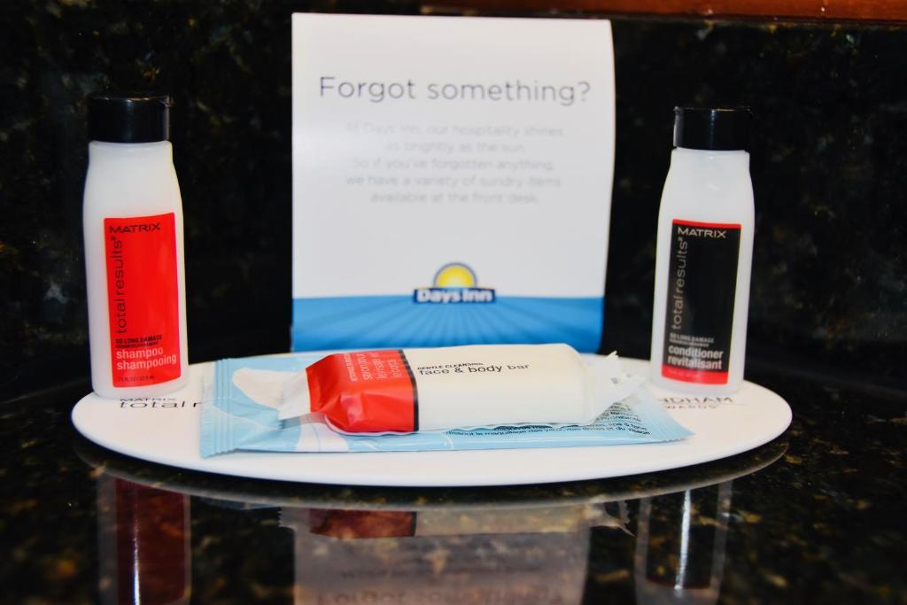 a table topped with two bottles of toothpaste at Days Inn by Wyndham Las Cruces in Las Cruces