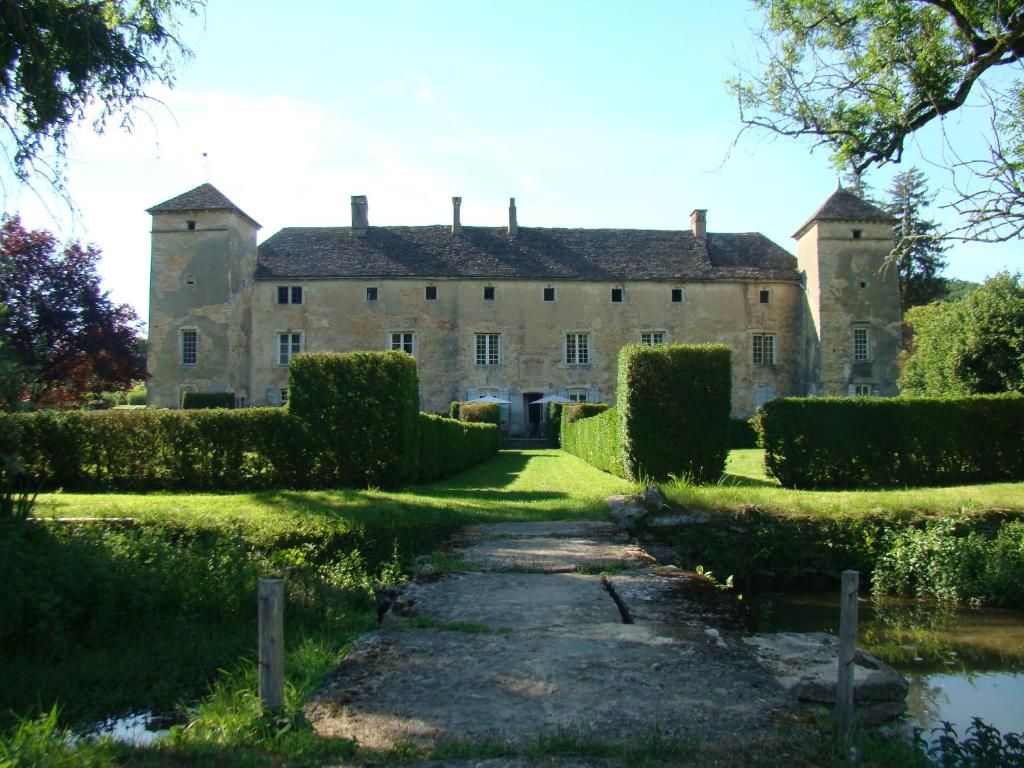 OzenayにあるChâteau d'Ozenayの前の小道を持つ古城