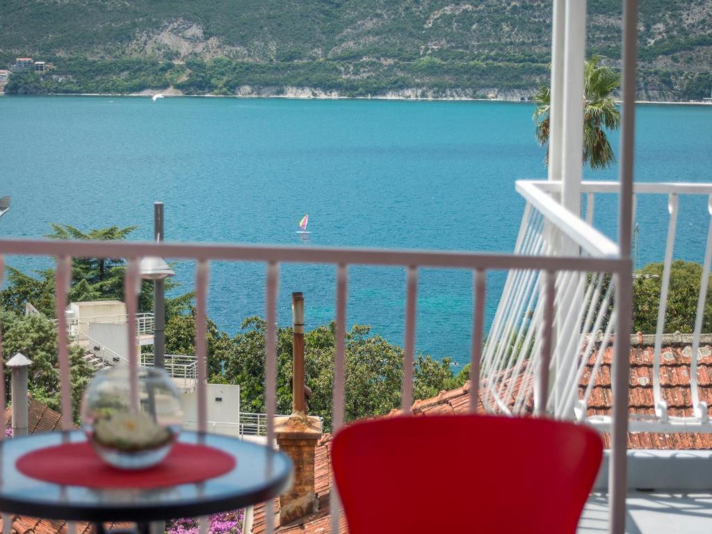 a view of the ocean from a balcony at Apartments and Rooms Bumerang in Herceg-Novi