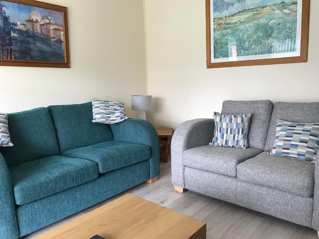 a living room with two couches and a chair at Suntana at Causeway Coast and Glens in Coleraine