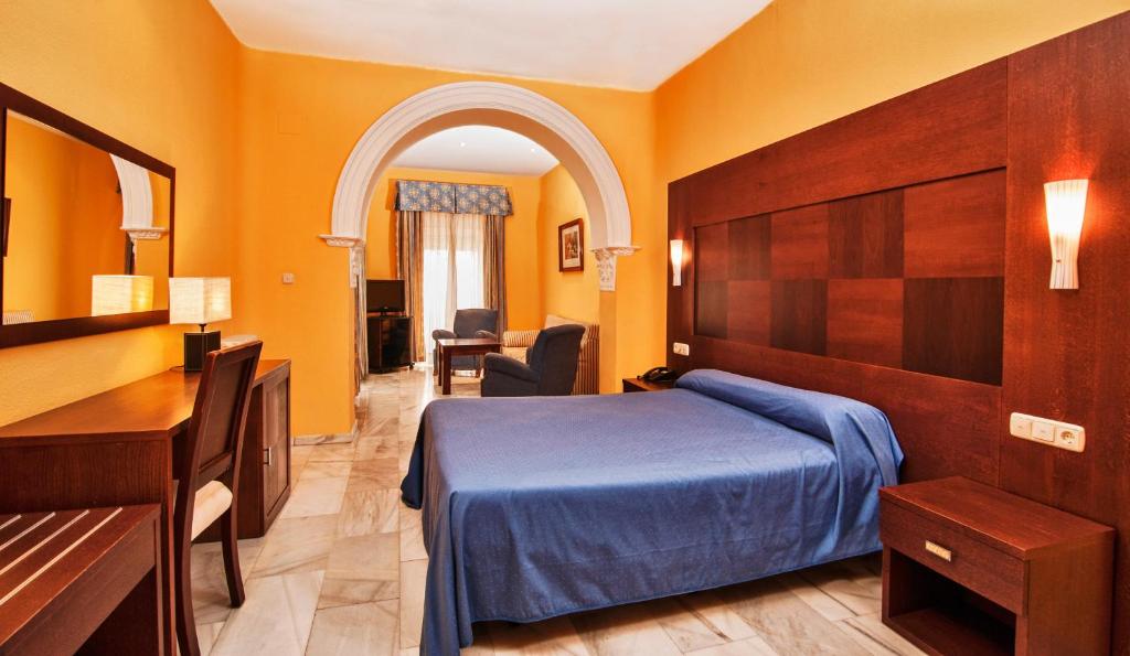 Postel nebo postele na pokoji v ubytování Hotel Nuevo Palas