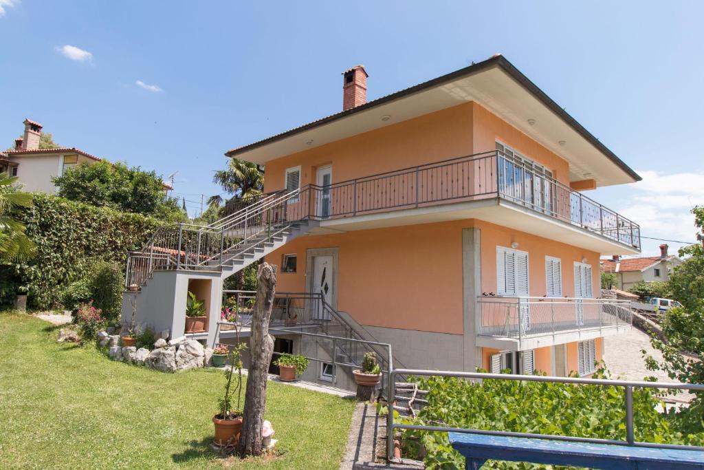 a house with a staircase in front of it at Apartments Vesna in Opatija