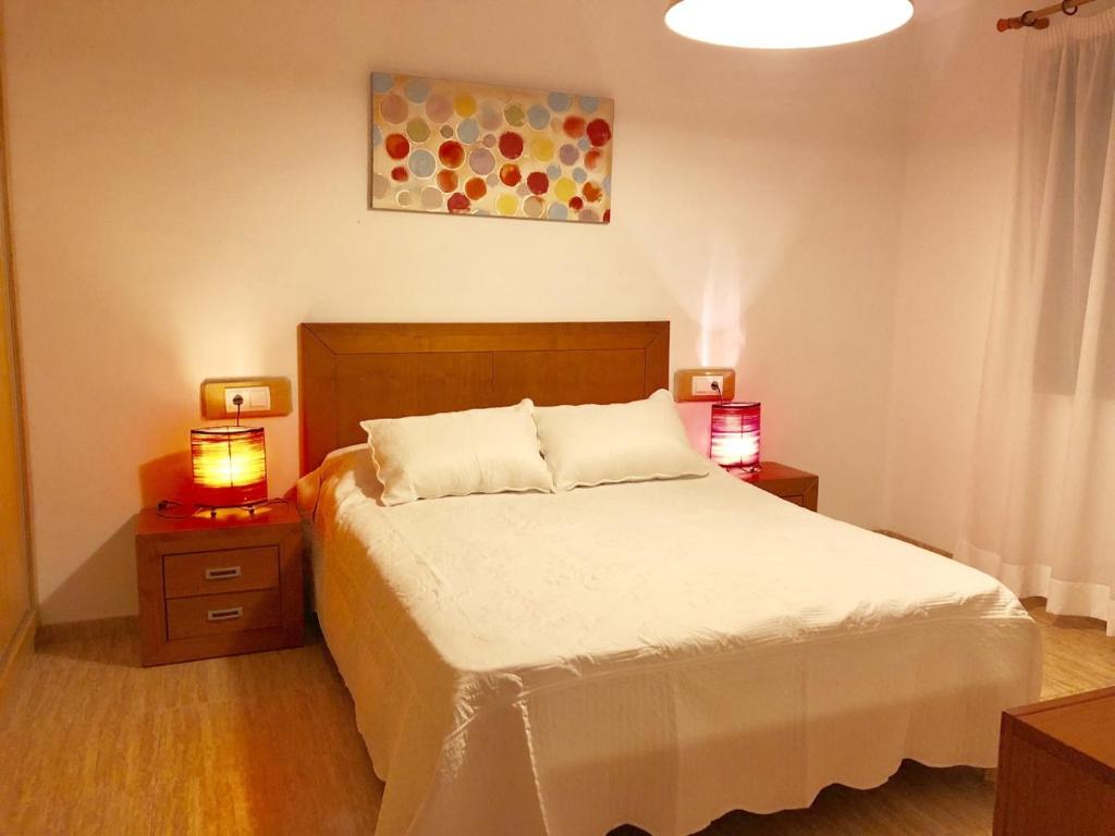 1 dormitorio con 1 cama y 2 lámparas en las mesas en Gaviotas 2 dormitorios Playa Sur, en Peñíscola