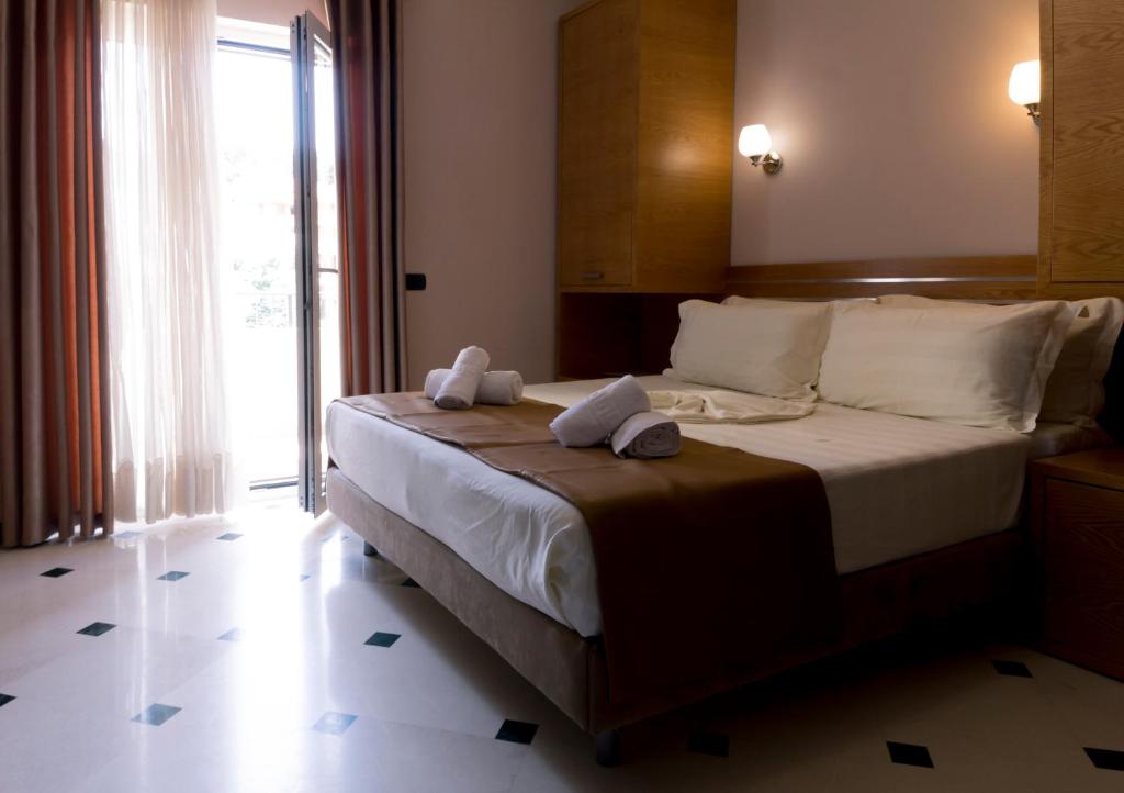Postel nebo postele na pokoji v ubytování Hotel Pandora Residence