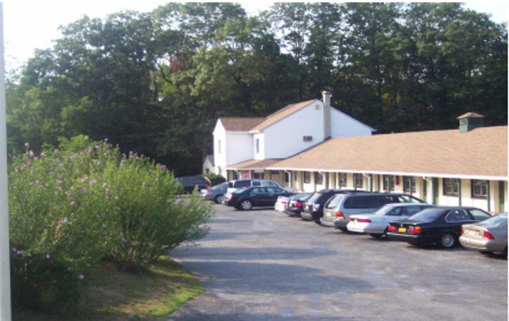 a row of cars parked in front of a building at Shore Hills Motel in Manasquan