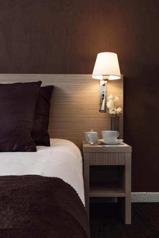 Postel nebo postele na pokoji v ubytování Hôtel de l'Étoile