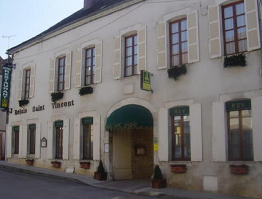 
a building with a large window on the side of it at Le Relais Saint Vincent in Ligny-le-Châtel
