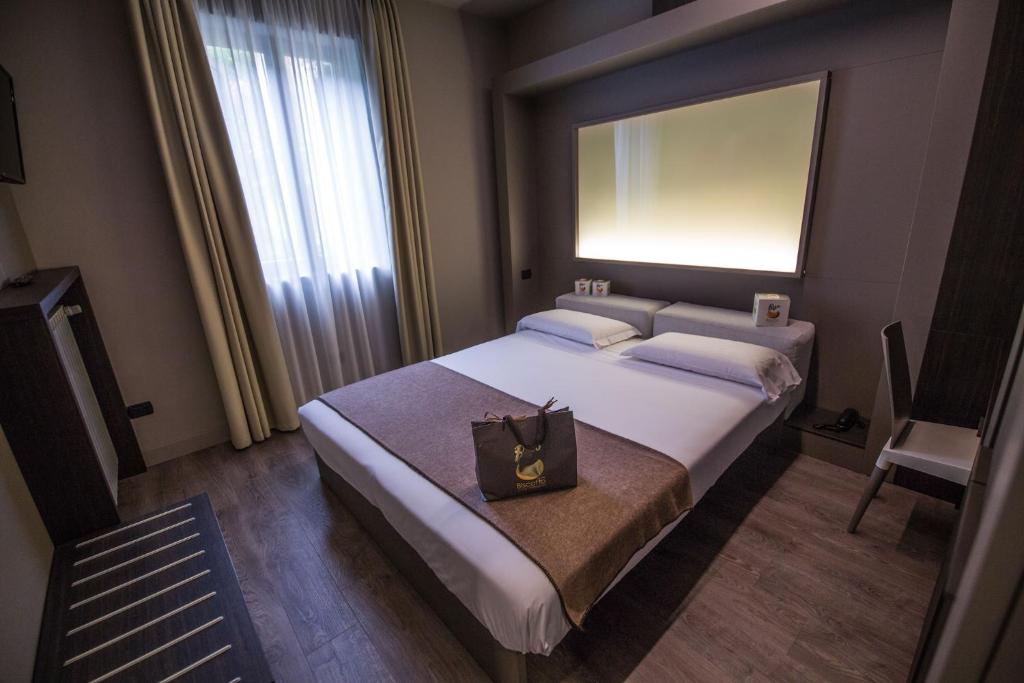 Postel nebo postele na pokoji v ubytování Hotel Bigio