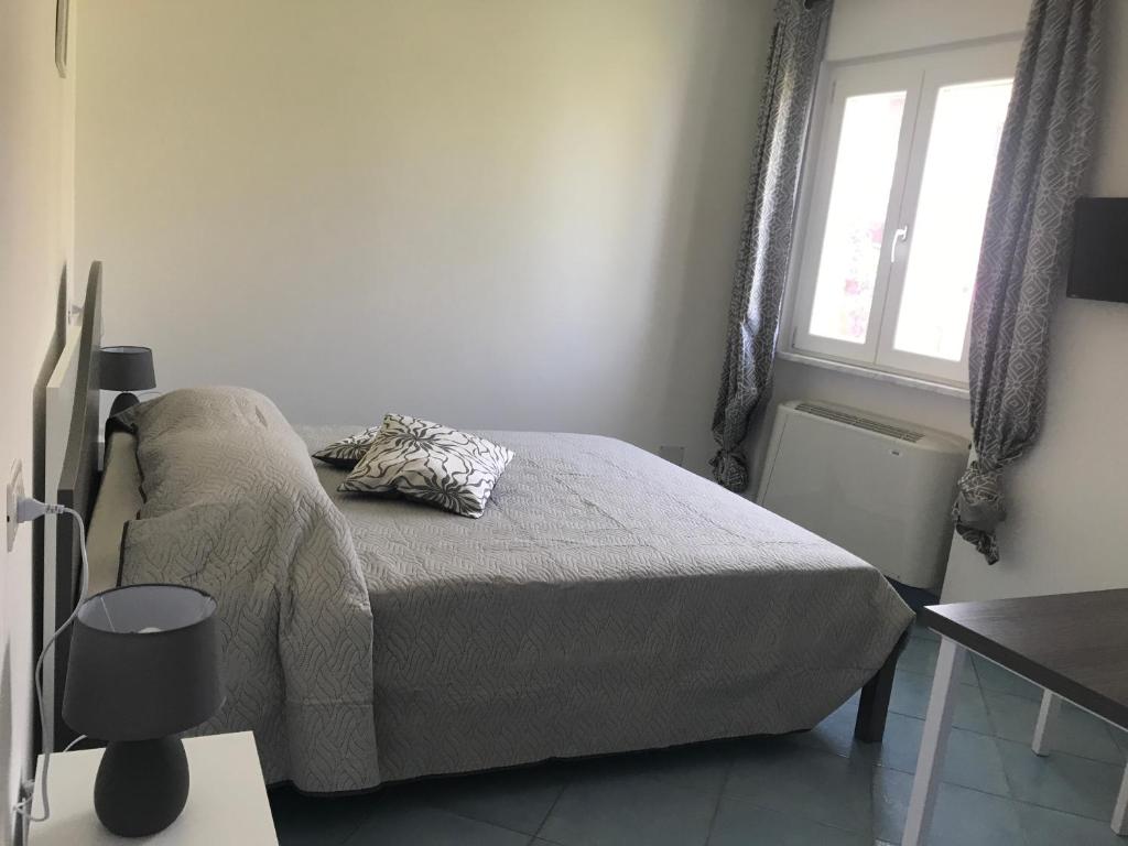 a small bedroom with a bed and a window at Nereide in Tropea
