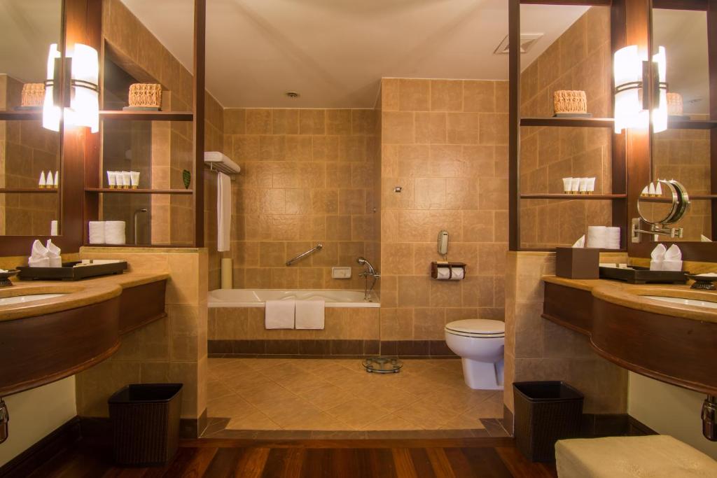 a bathroom with a tub and a toilet and a sink at Palace Residence & Villa Siem Reap in Siem Reap